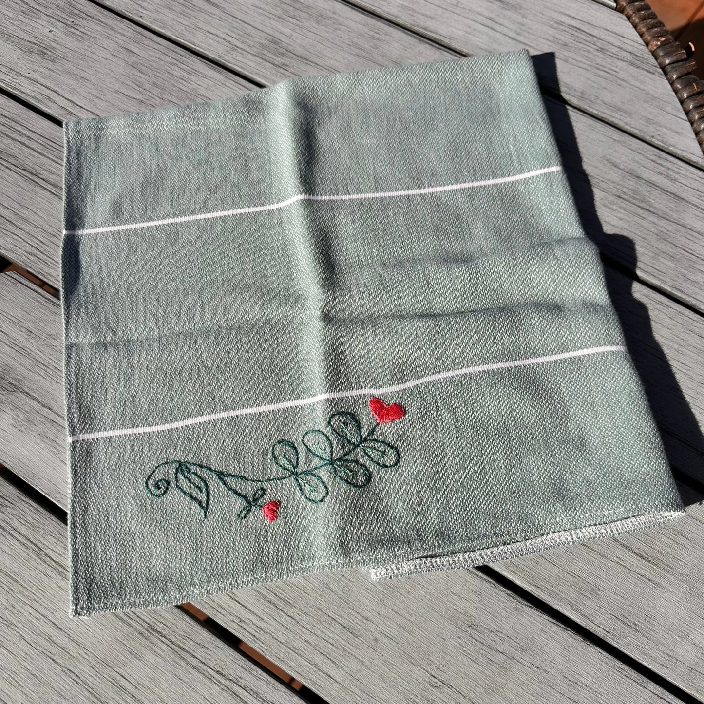 Embroidered fabric with decorative elements on a wooden surface