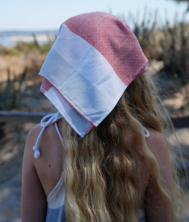 Backview of a red, blue and white  bandana being worn as a headband on young girl