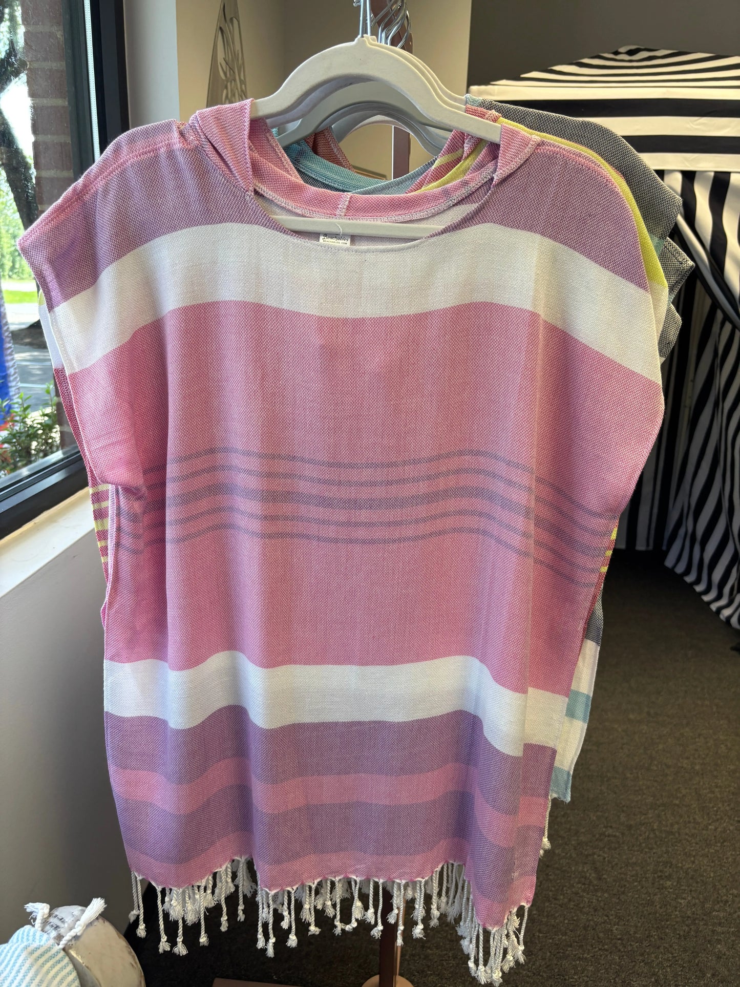 hooded poncho on a hanger with pink, purple and white stripes