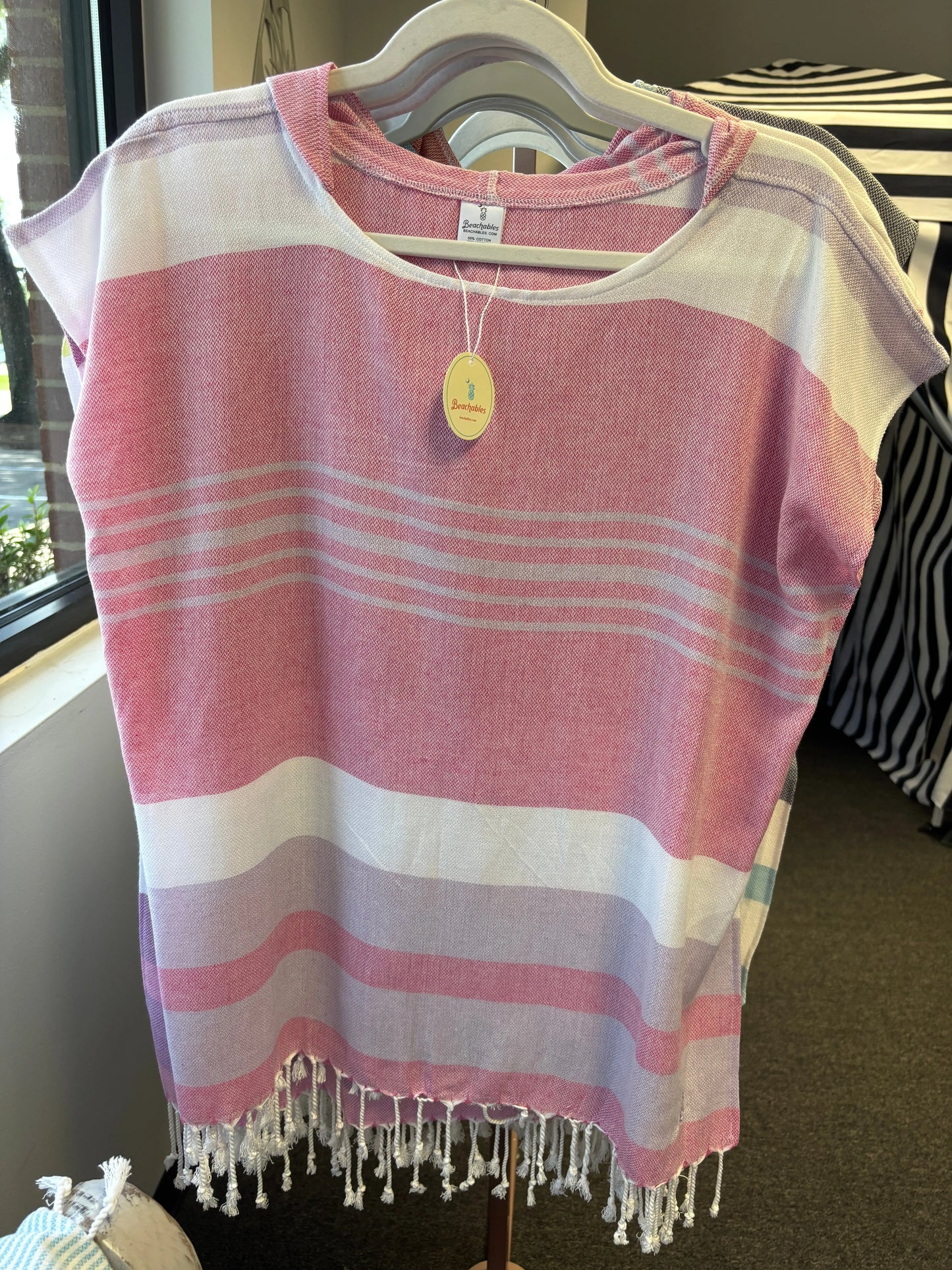 hooded poncho on a hanger with pink, purple and white stripes