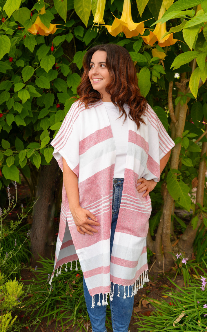 Woman in blue, red and white stripe mid-length cover-up in outdoor setting