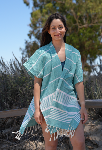 Woman in green stripe mid-length cover-up in outdoor setting