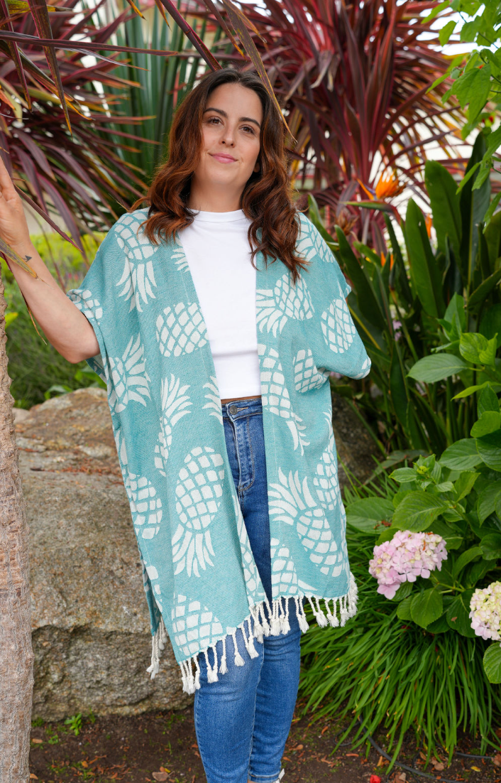 Woman in green pineapple print mid-length cover-up in outdoor setting