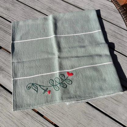 Embroidered fabric with decorative elements on a wooden surface