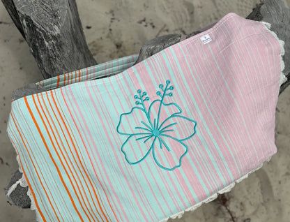 Striped bag with Hibiscus design on a wooden surface