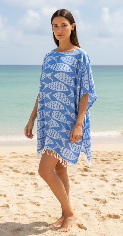 Woman wearing a blue fish-patterned cover-up on a beach