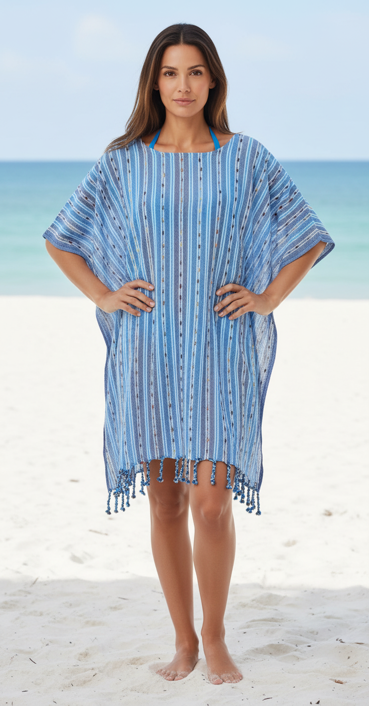 Woman wearing a blue patterned cover-up on a beach