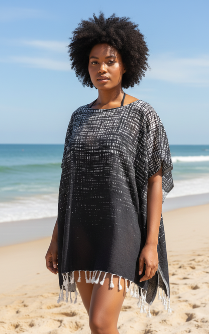 Woman wearing a black and white patterned cover-up on a beach