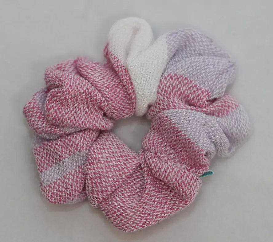 Pink and purple scrunchie on a light gray background