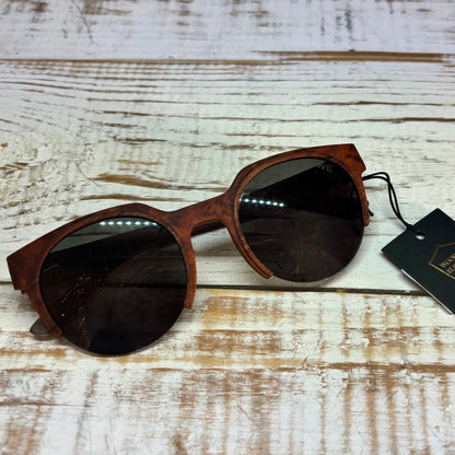 Wooden-framed sunglasses with a tag on a wooden surface